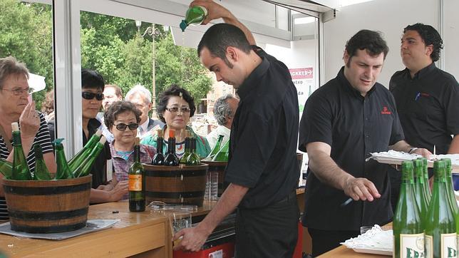 Asturianos en un local escanciando sidra