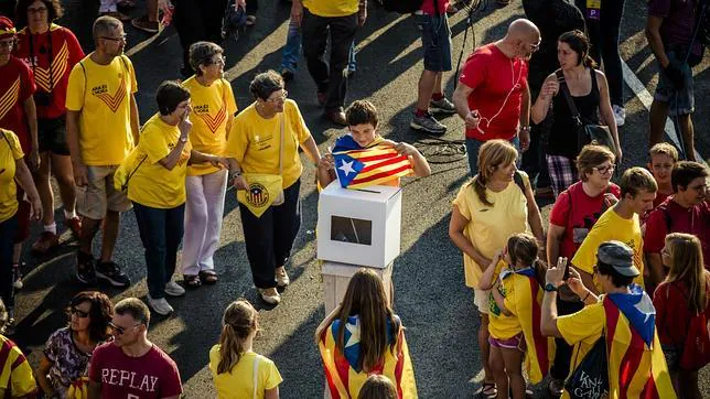 Partidarios de la independencia rodean a un niño con una urna