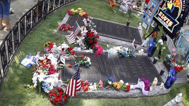 Varios aficionados visitan la tumba de Elvis.