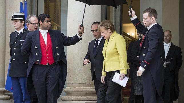 La canciller alemana, Angela Merkel (centro dcha), conversa con el presidente galo, François Hollande (centro izda), en París (Francia)