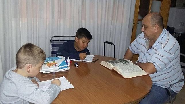 Abel con sus hijos en casa realizando tareas escolares