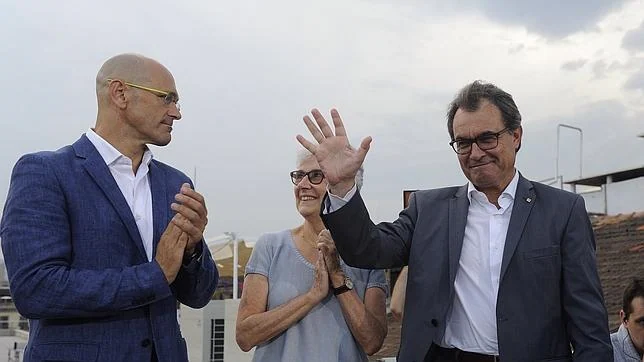 Artur Mas junto con el «número 1» de su lista, Raúl Romeva, y la presidenta de Òmnium, Muriel Casals