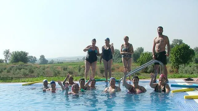 Un grupo de personas combate el calor bañándose en la piscina de Algallarín