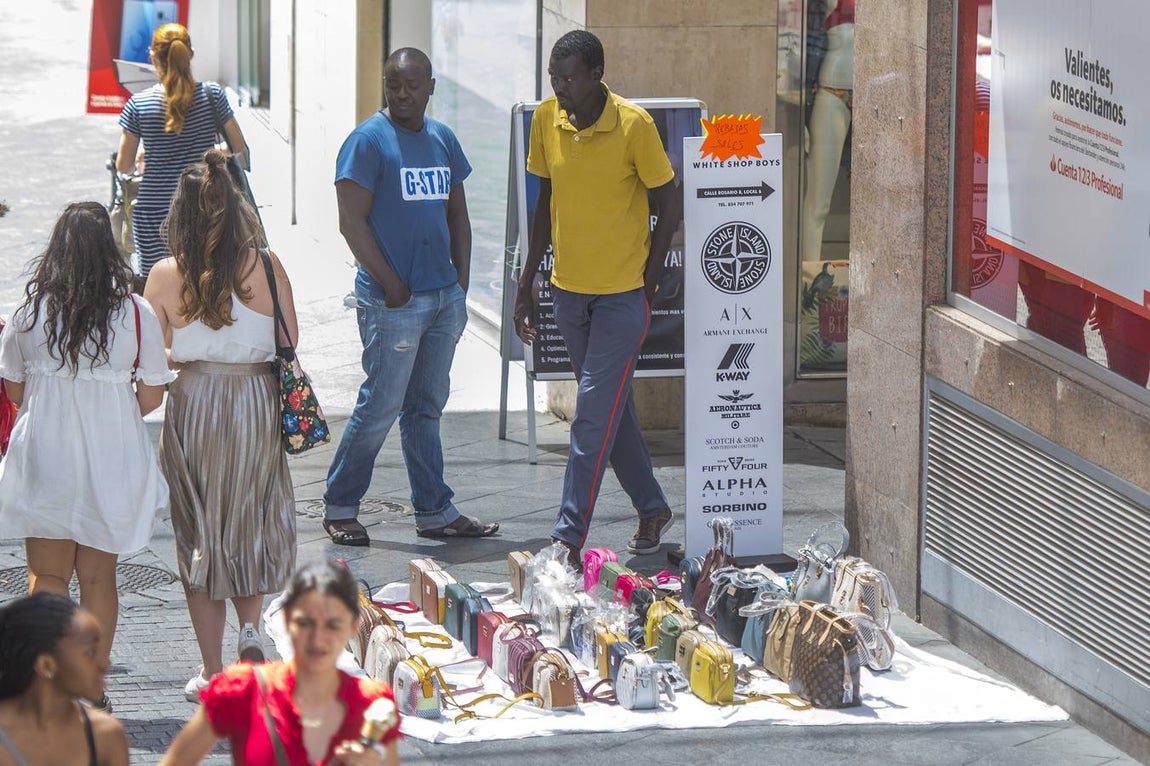 En imágenes, la calle Tetuán de Sevilla invadida por los manteros