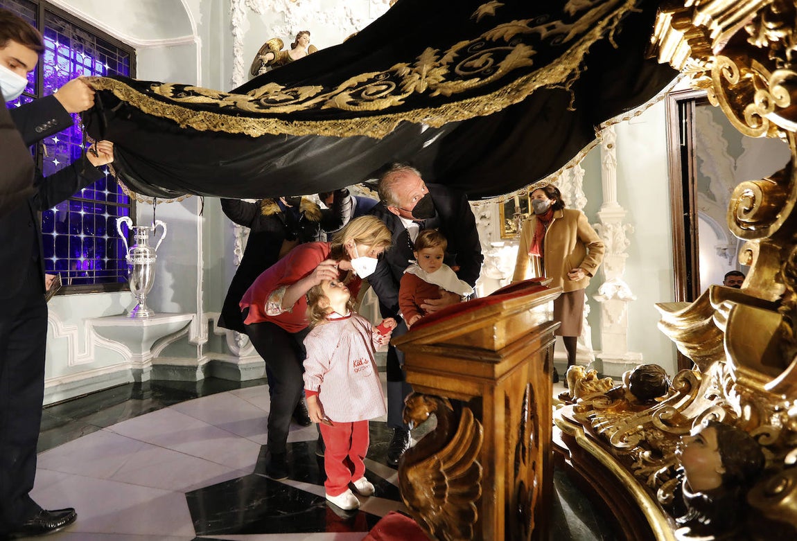 Los niños pasan bajo el manto de la Virgen de los Dolores de Córdoba, en imágenes