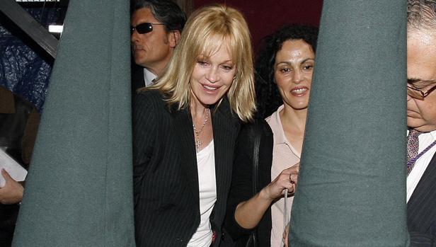 La actriz Melanie Griffith habla con un un niño nazareno en la Iglesia de San Juan desde donde sale el trono de la Virgen de Lágrimas y Favores