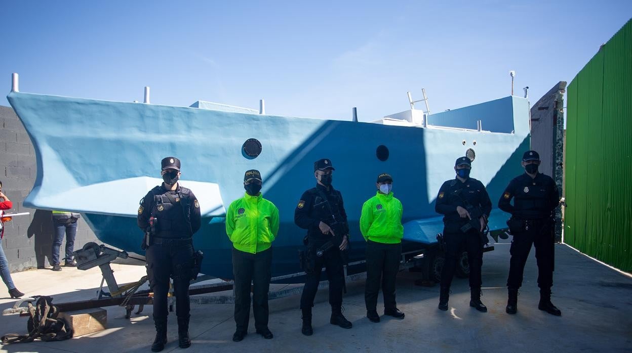 Policías nacionales y agentes colombianas, junto a la embarcación