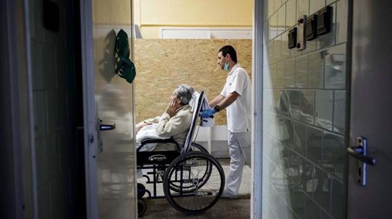 Un celador con una paciente