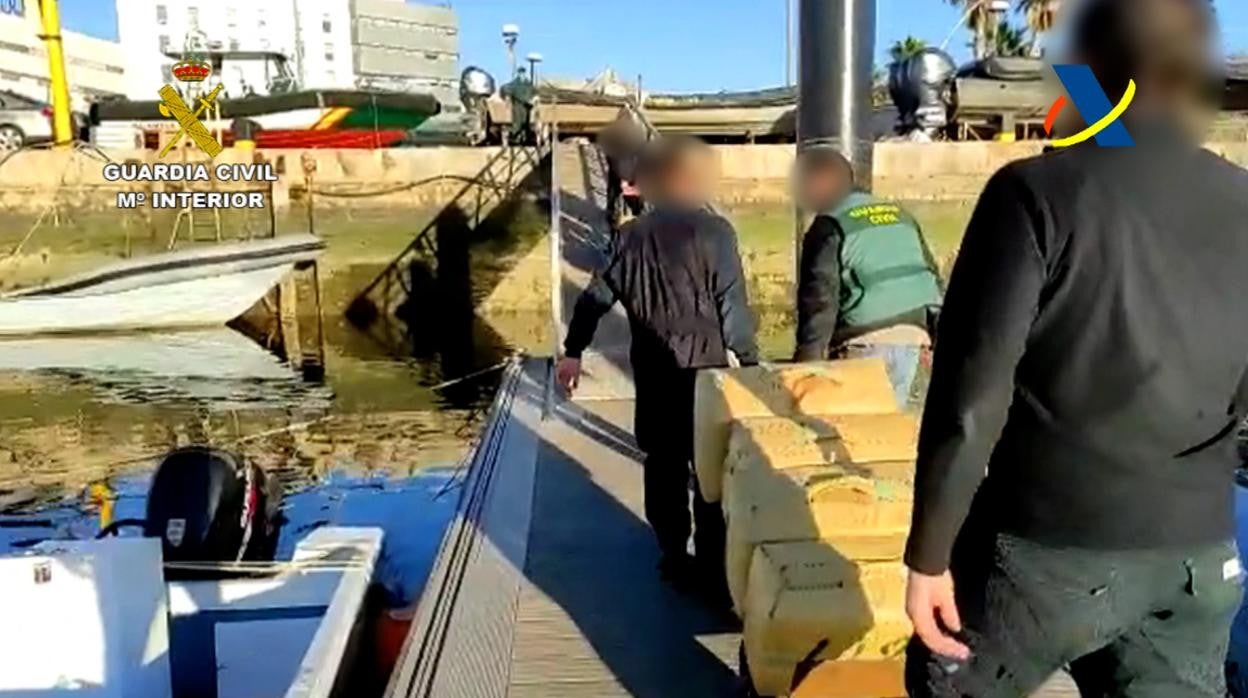 Agentes transportan parte de la droga incautada en la operación en Ayamonte