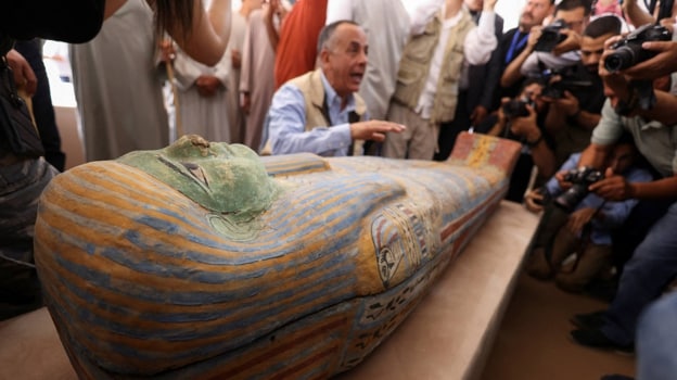 Mostafa Waziri shows the press one of the sarcophagi discovered
