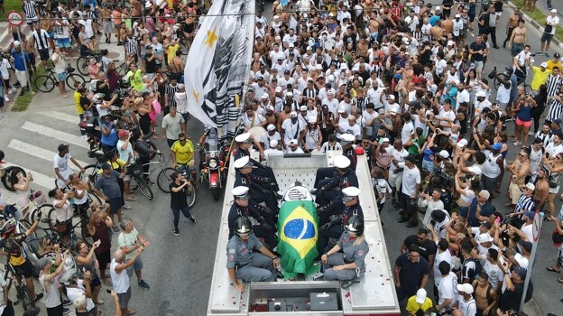 Pelé's coffin transported in a fire truck through the streets of Santos