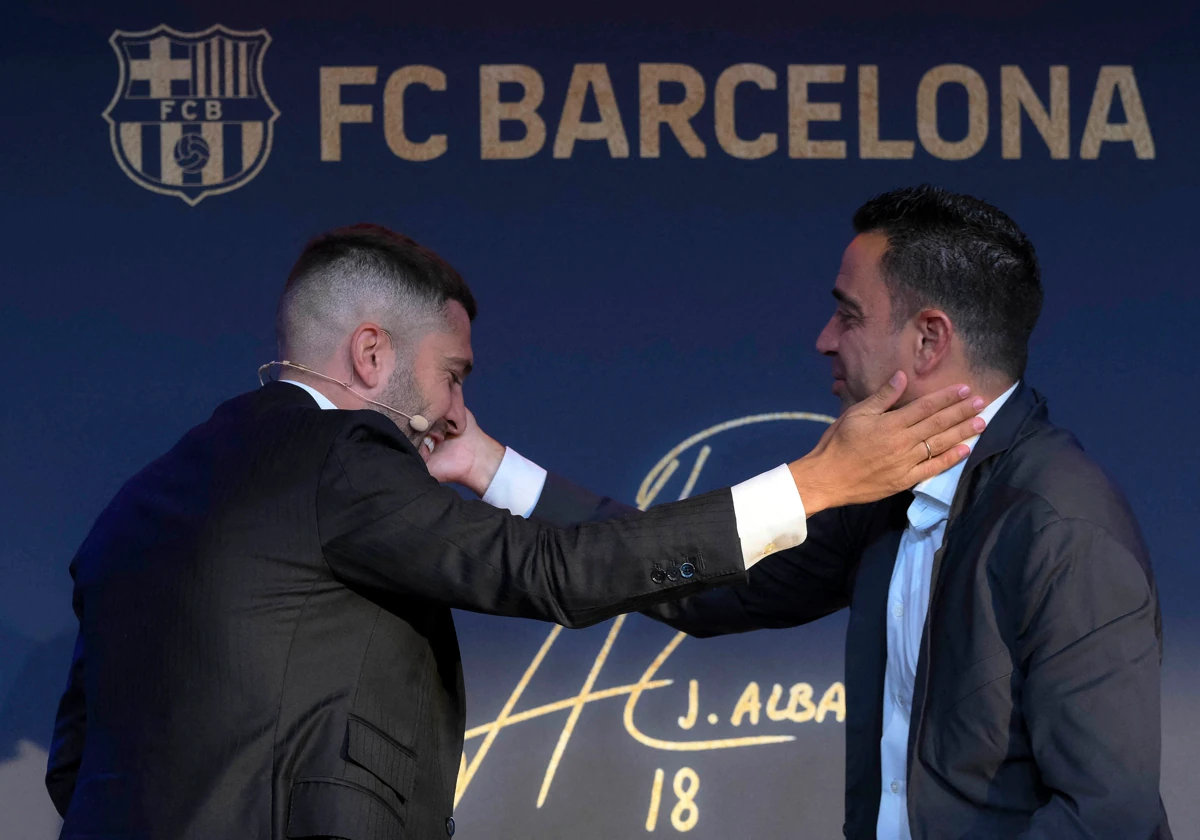Jordi Alba y Xavi se saludan en el acto de homenaje al lateral azulgrana