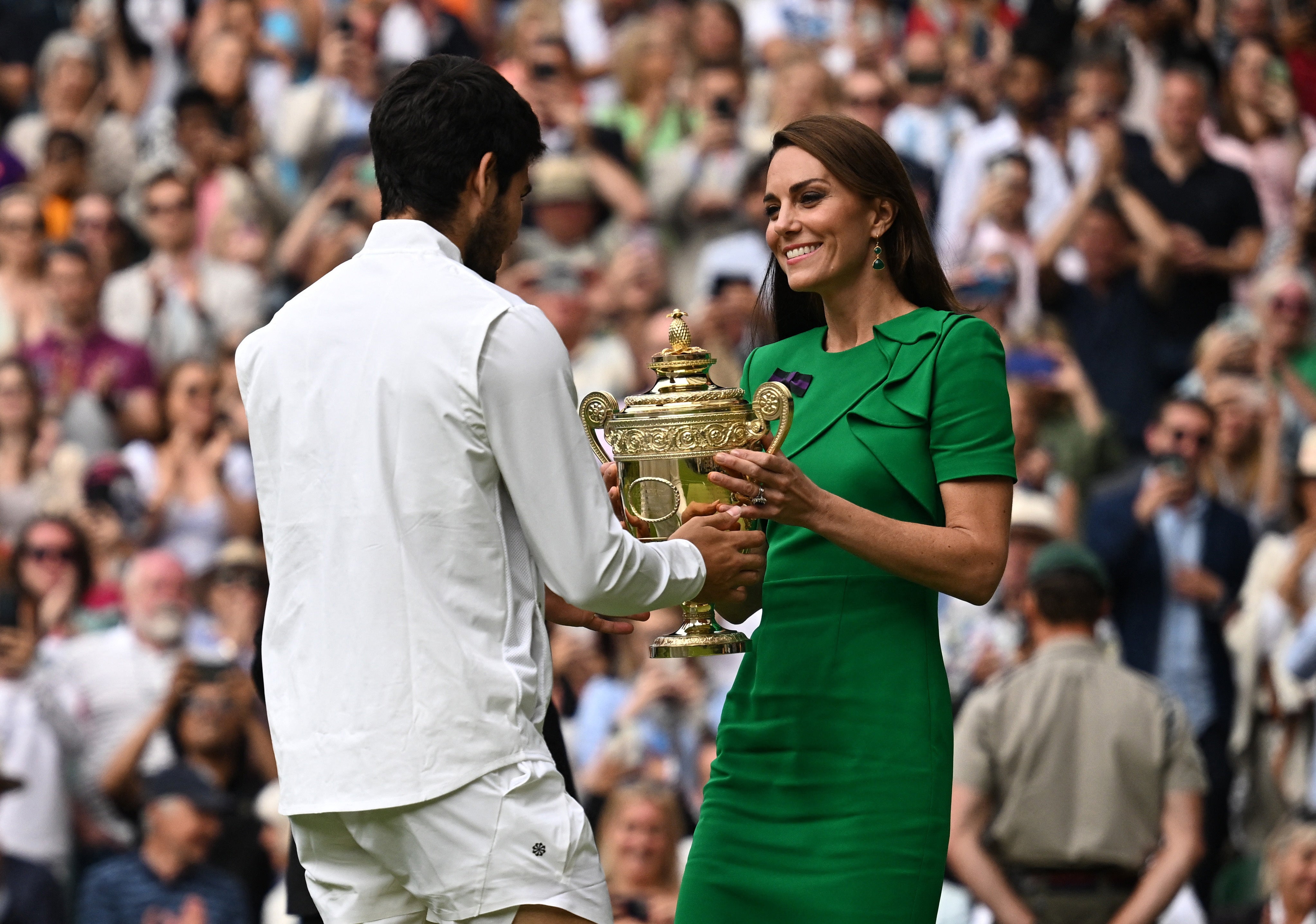 El español Carlos Alcaraz recibe el trofeo de manos de la princesa británica Kate de Gales tras ganar su partido final contra el serbio Novak Djokovic.