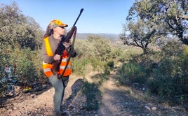Imagen de una joven, sosteniendo un arma, durante una jornada de caza