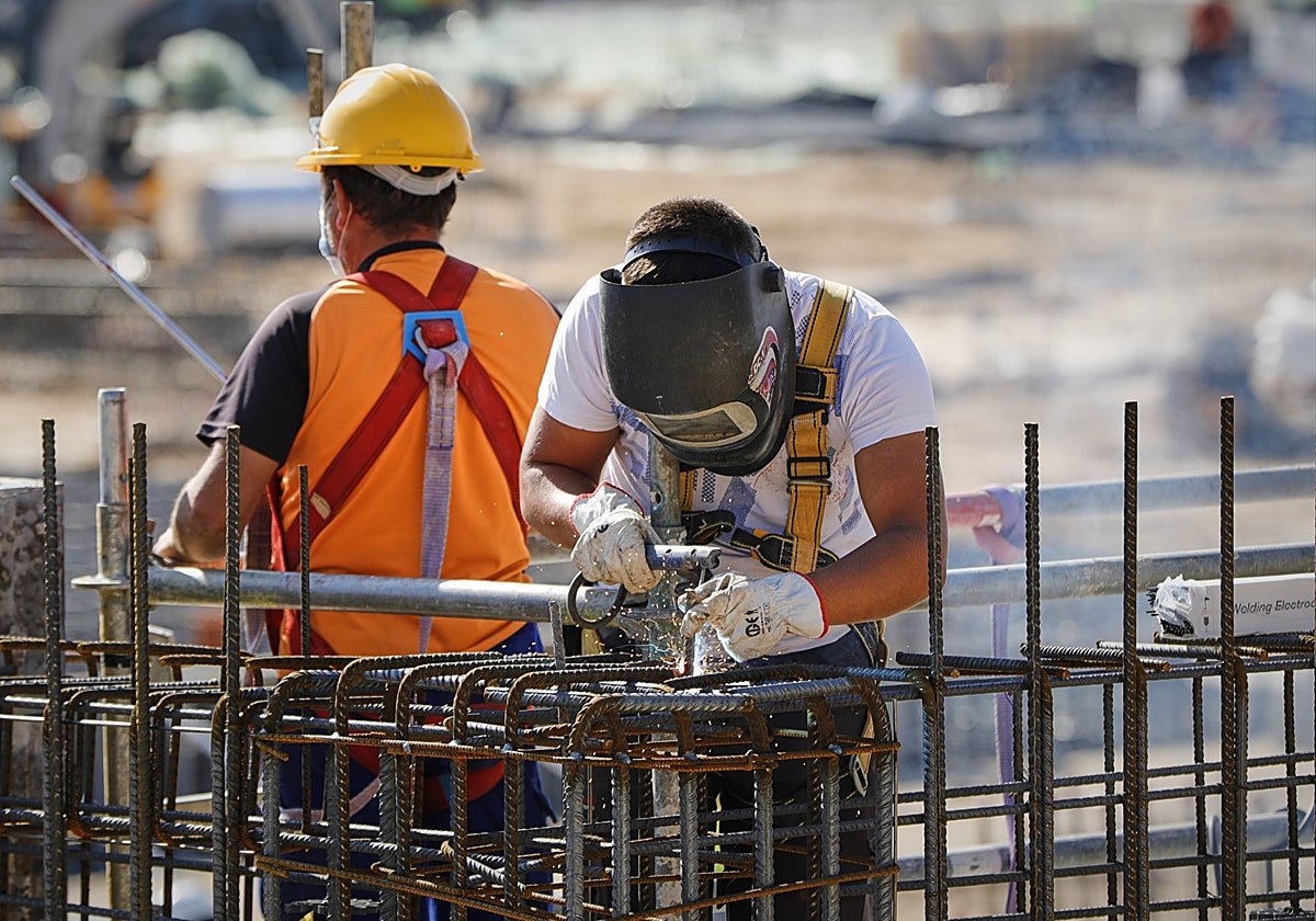 Un soldador y un operario durante una jornada de trabajo