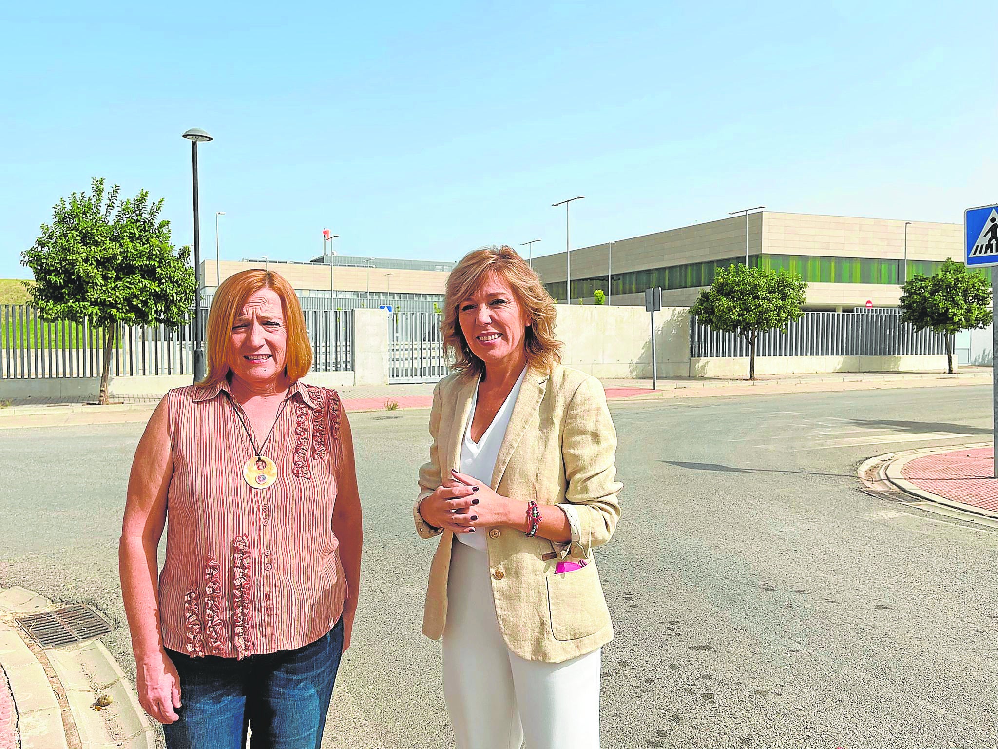 La alcaldesa palmeña y la parlamentaria Ana Romero con el hospital de Palma del Río al fondo