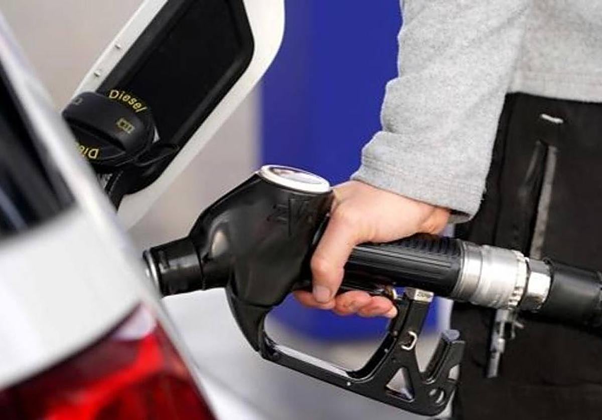 Un conductor llenando el depósito de su vehículo