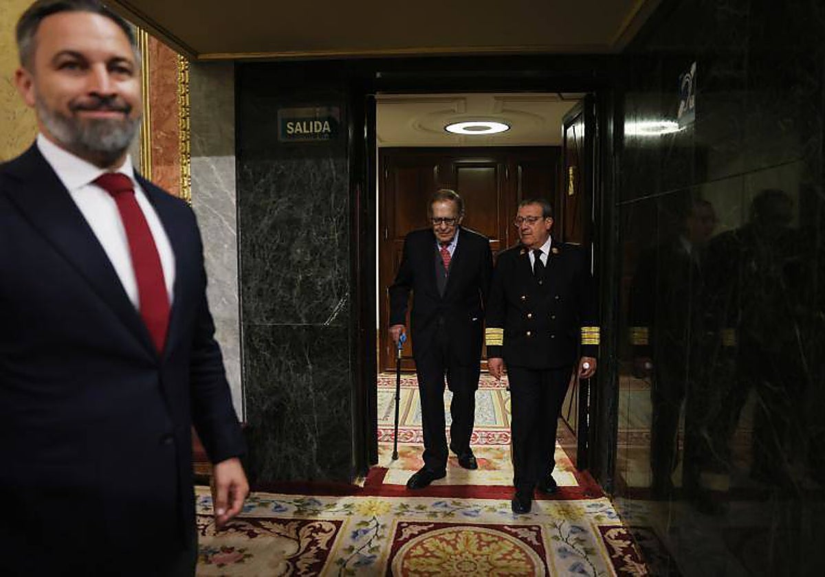 Santiago Abascal, sonriente, espera a Ramón Tamames, que conversa de fondo con un ujier del Congreso