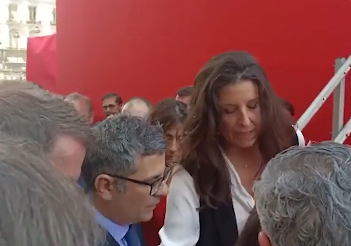 Félix Bolaños trata de subir a la tribuna durante el Dos de Mayo