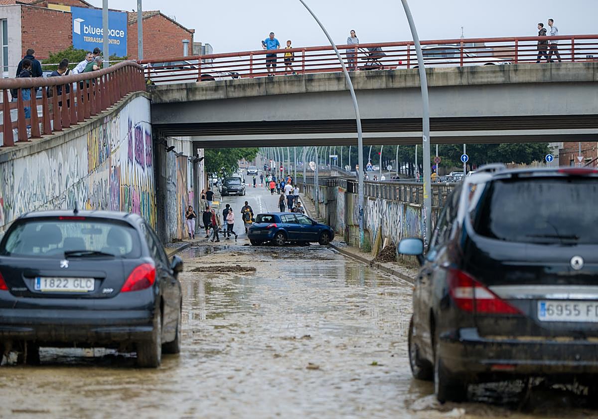 Varios coches se quedan atascados en la vía por las inundaciones en las calles de Terrassa, Barcelona