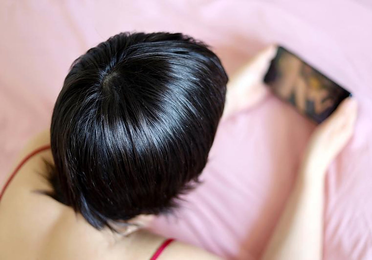 Una mujer utilizando un móvil, en una imagen de archivo