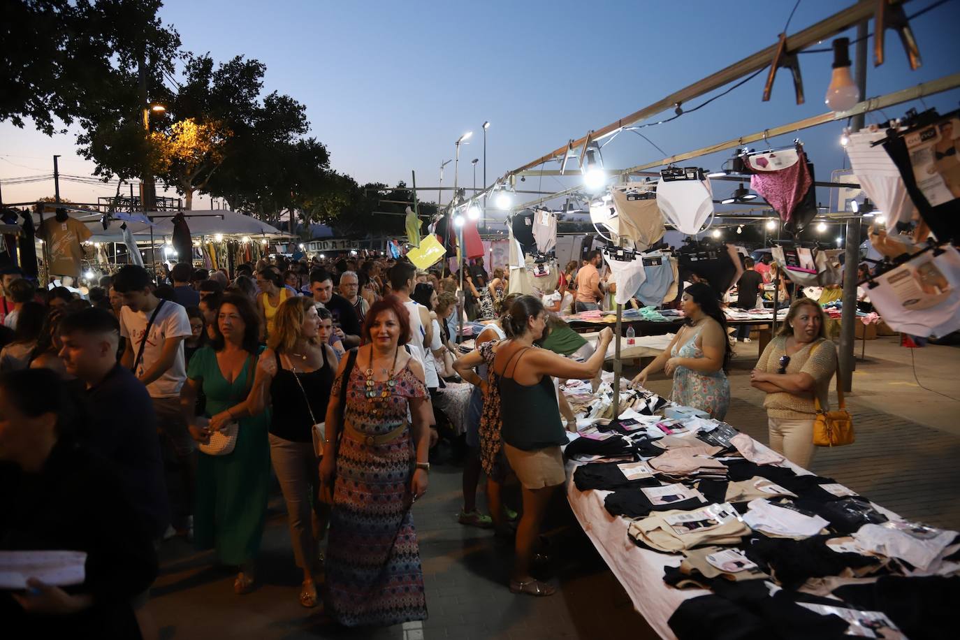 El bullicioso mercadillo del Arenal en horario nocturno, en imágenes