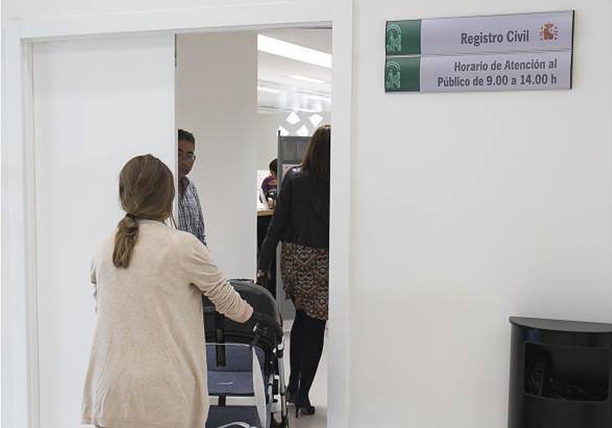 Una madre entra con su hijo a inscribirlo en el Registro Civil de Córdoba