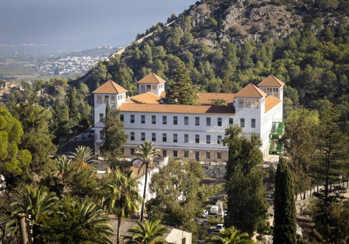 Vista panorámica general del edificio principal del sanatorio de la Fundación Fontilles, con la muralla en la cresta de la montaña.