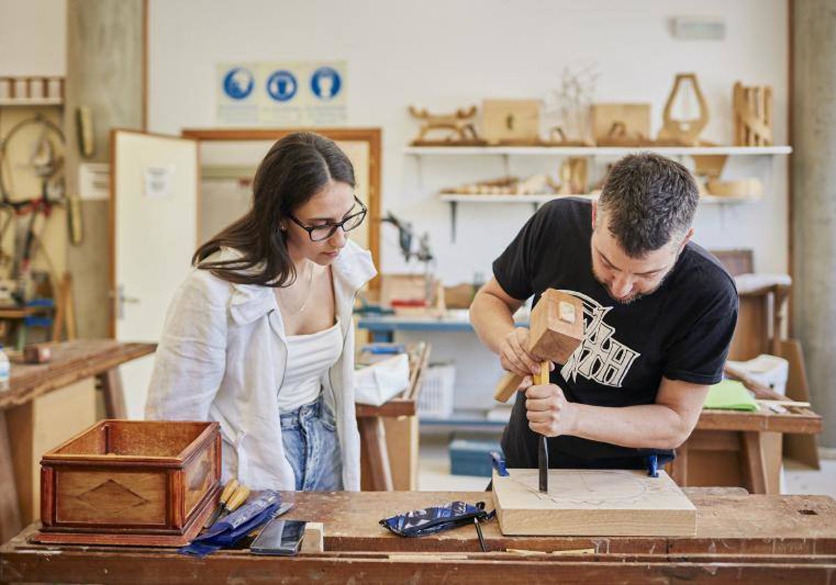 Dos estudiantes de FP trabajan con madera en la EASD Antonio Faílde, en Orense (archivo)