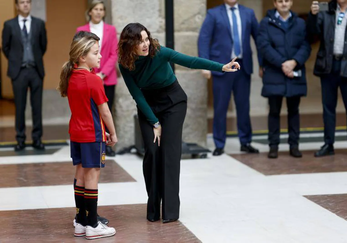La presidenta Díaz Ayuso, con dos pequeñas aficionadas, en la Real Casa de Correos