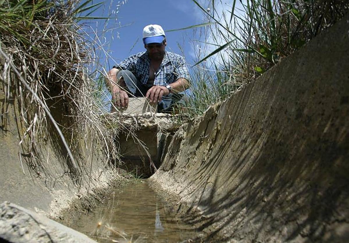 UIn agricultor procediendo al riego de sus campos