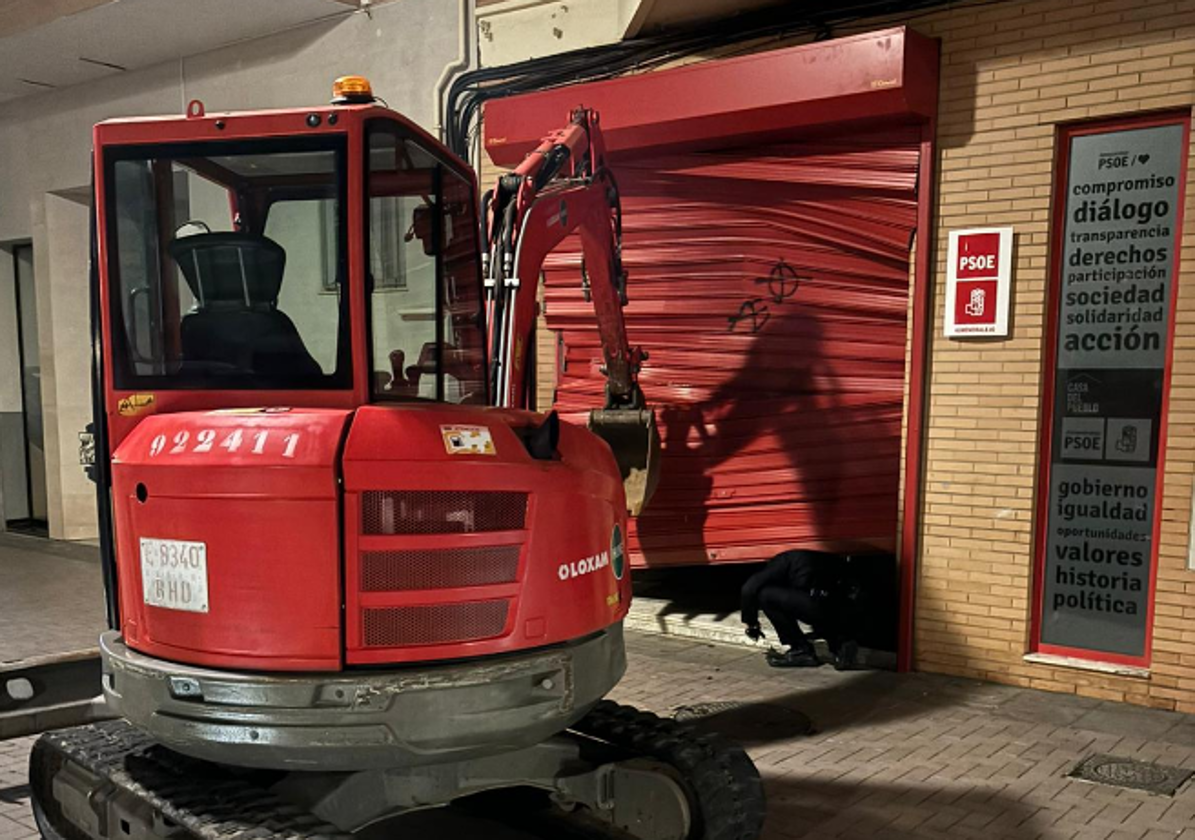 La retroexcavadora frente a la sede del PSOE en Almendralejo (Badajoz)
