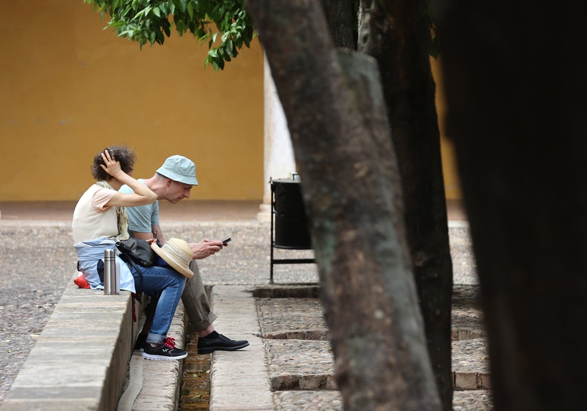 Dos turistas en el Patio de los Naranjos
