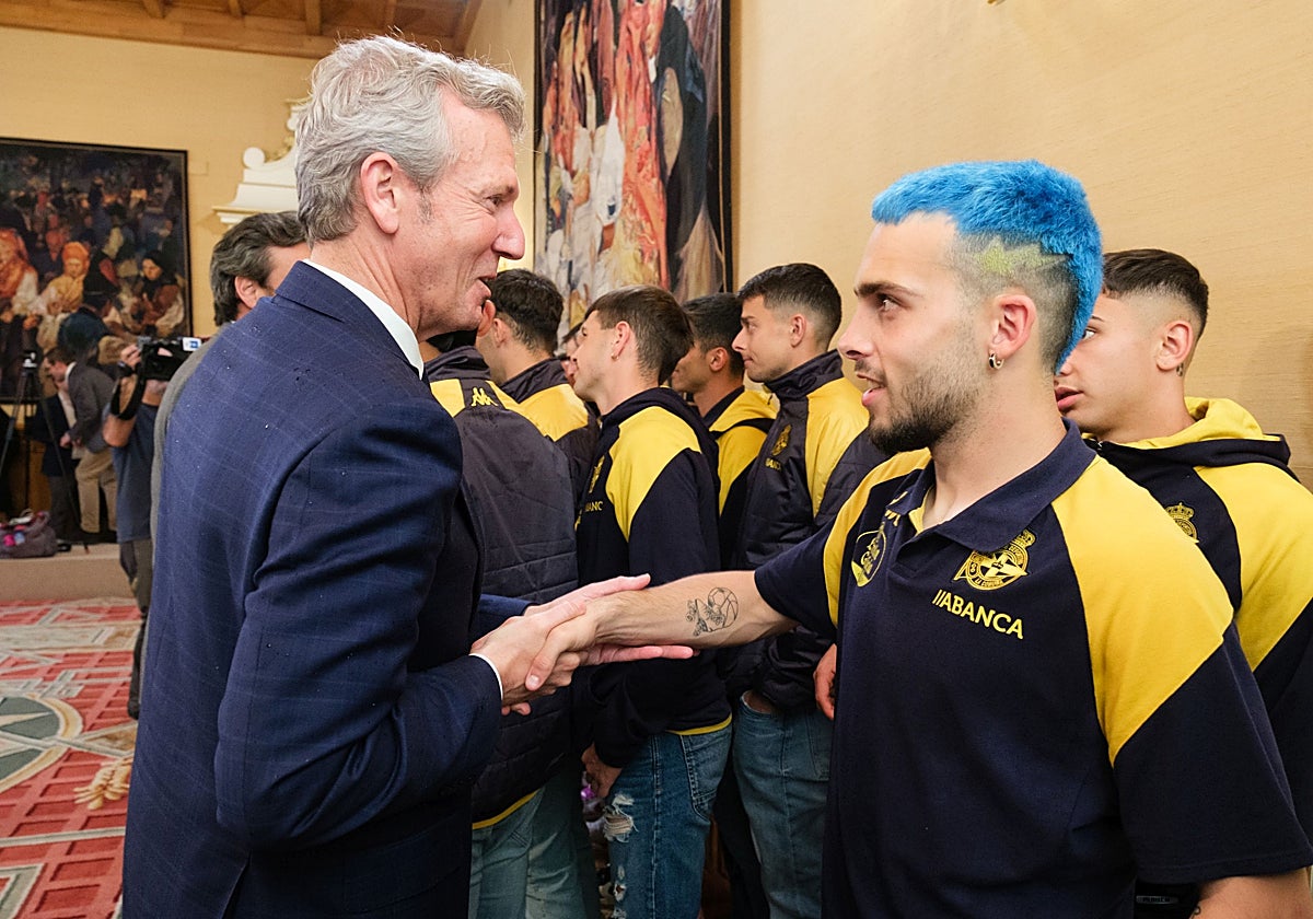 Rueda saluda a David Mella, jugador del Deportivo, este lunes en el Pazo de Raxoi