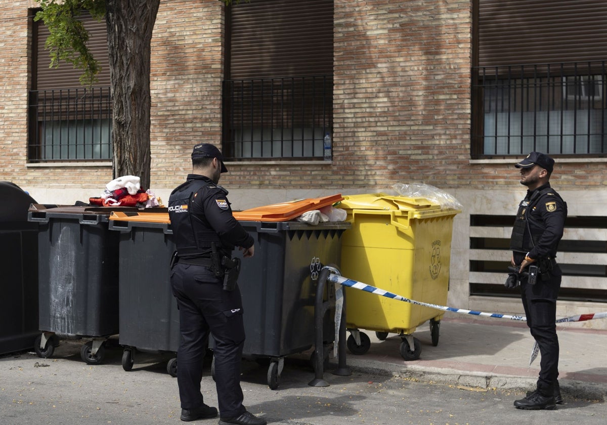 Dos policías, junto a los contenedores en los que estaba el bebé, el pasado 12 de mayo