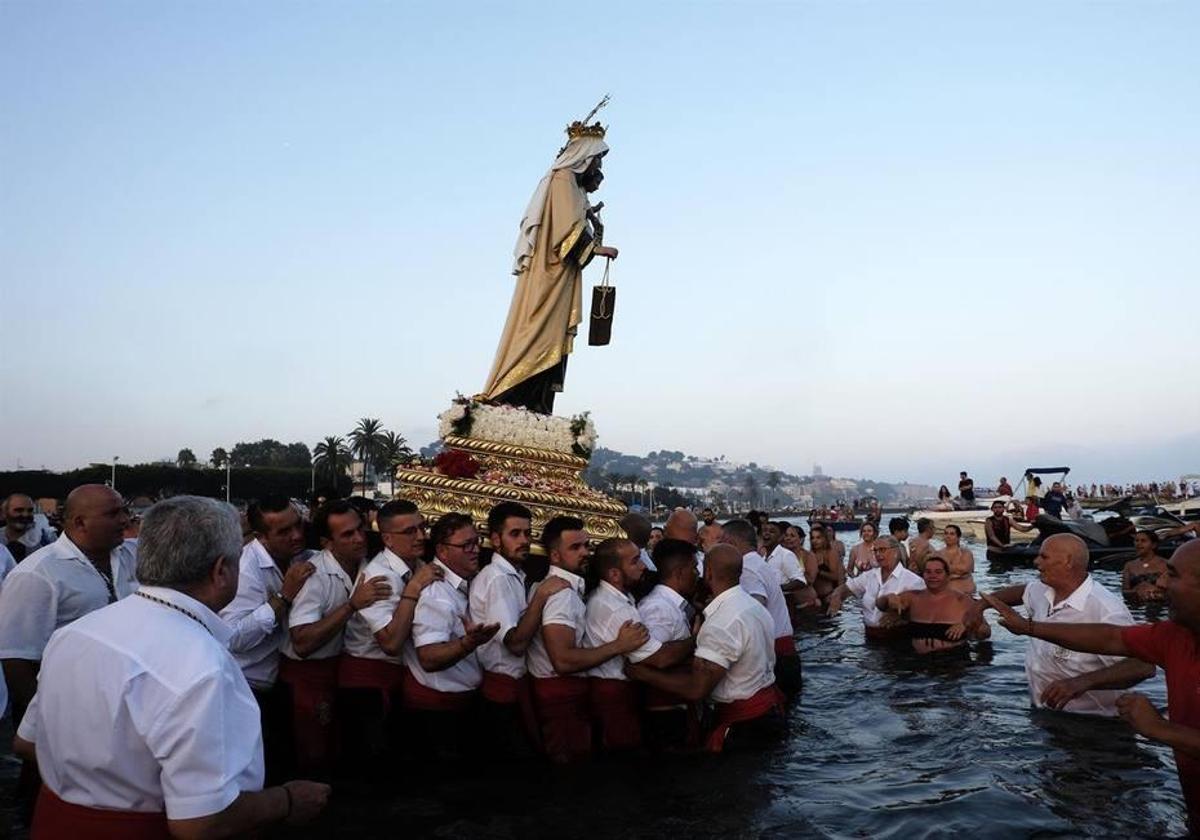 La Virgen del Carmen, de la barriada del Palo, internándose en el mar