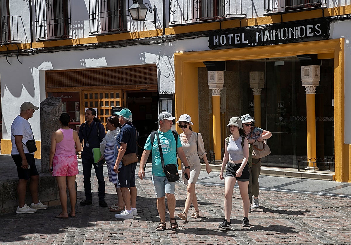Turistas extranjeros salen de un hotel de Córdoba en pleno verano