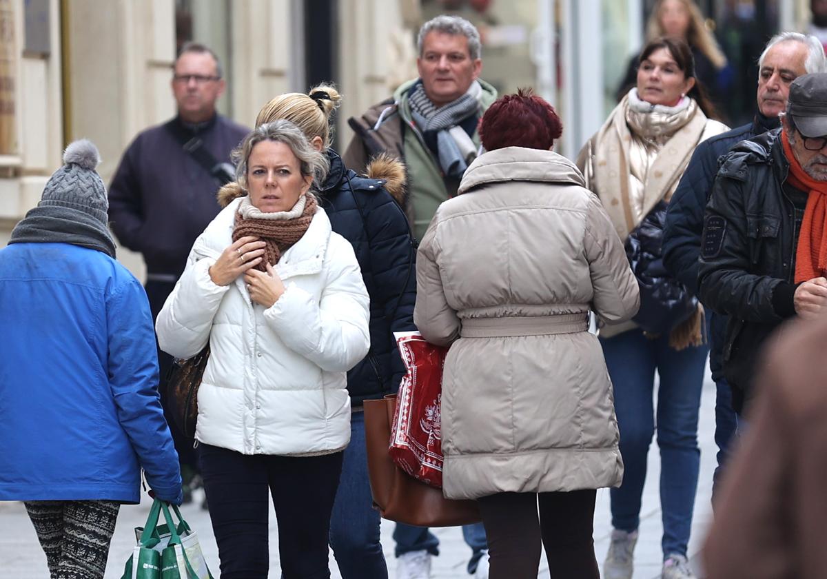 Varias personas pasean abrigadas por el Centro de Córdoba