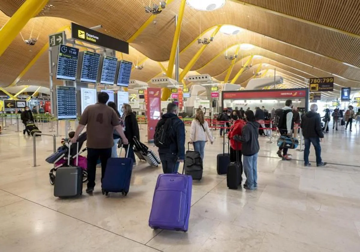 Viajeros con maletas en la terminal T-4 en el Aeropuerto Adolfo Suárez Madrid-Barajas, en una imagen de archivo