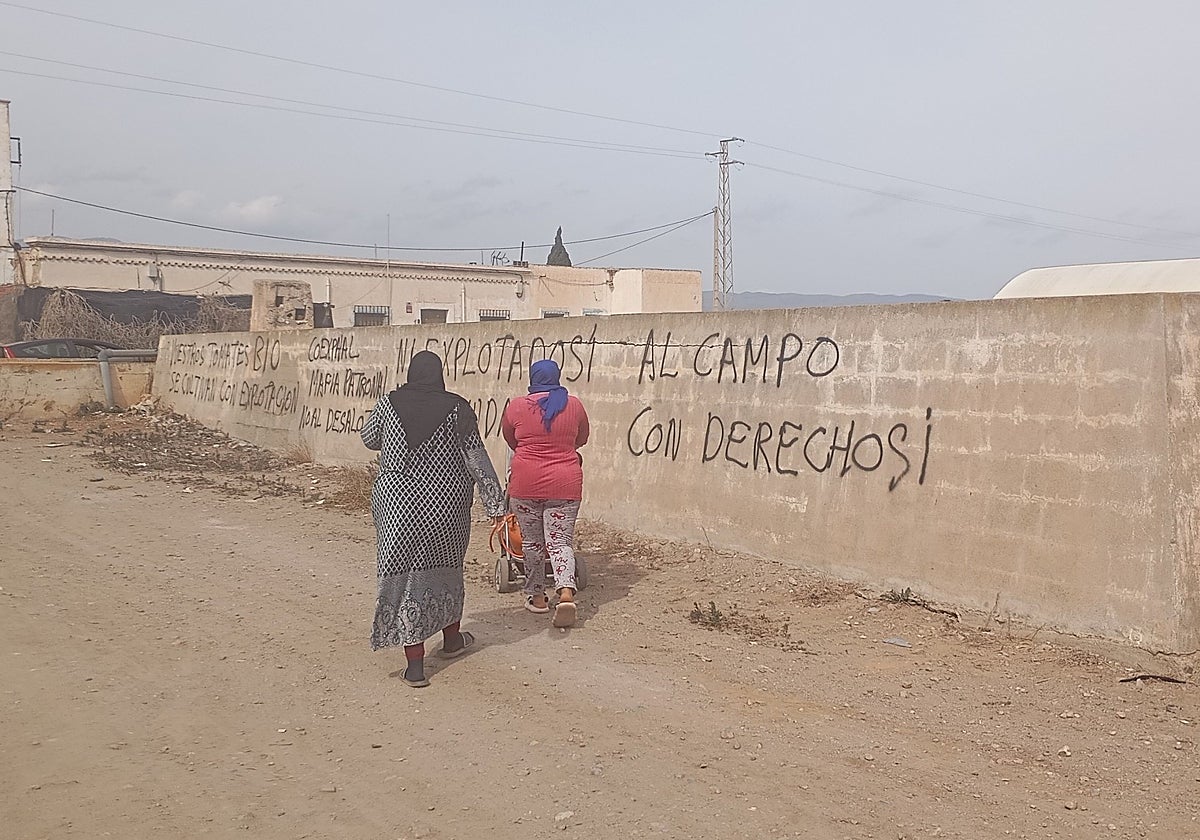 Dos mujeres transitan por el poblado chabolista que ha sido desalojado