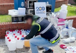 Un agente de la Policía Nacional recoge los útiles empleados por la red para procesar la cocaína