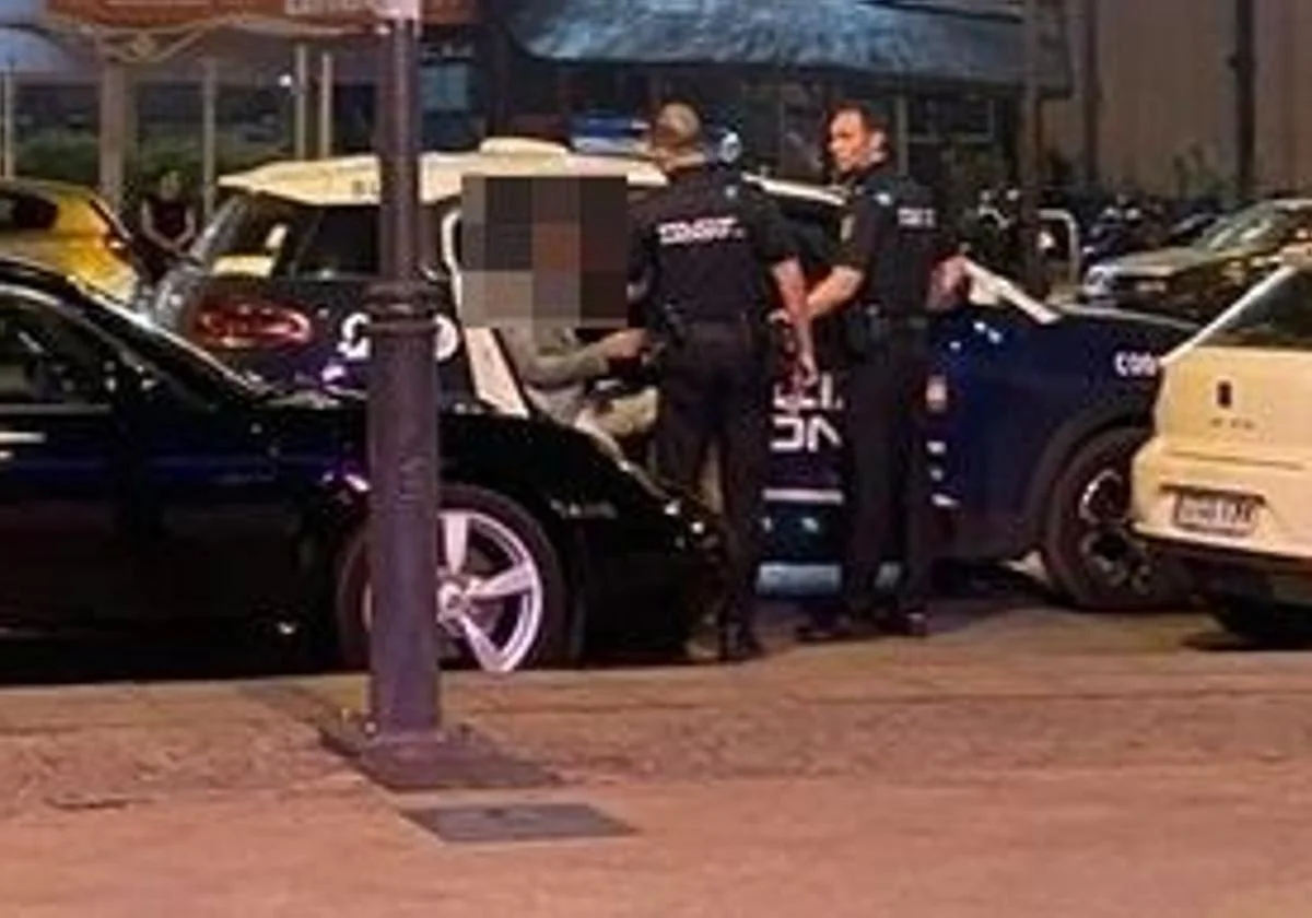 El directdor es introducido en un coche de la Policía Nacional