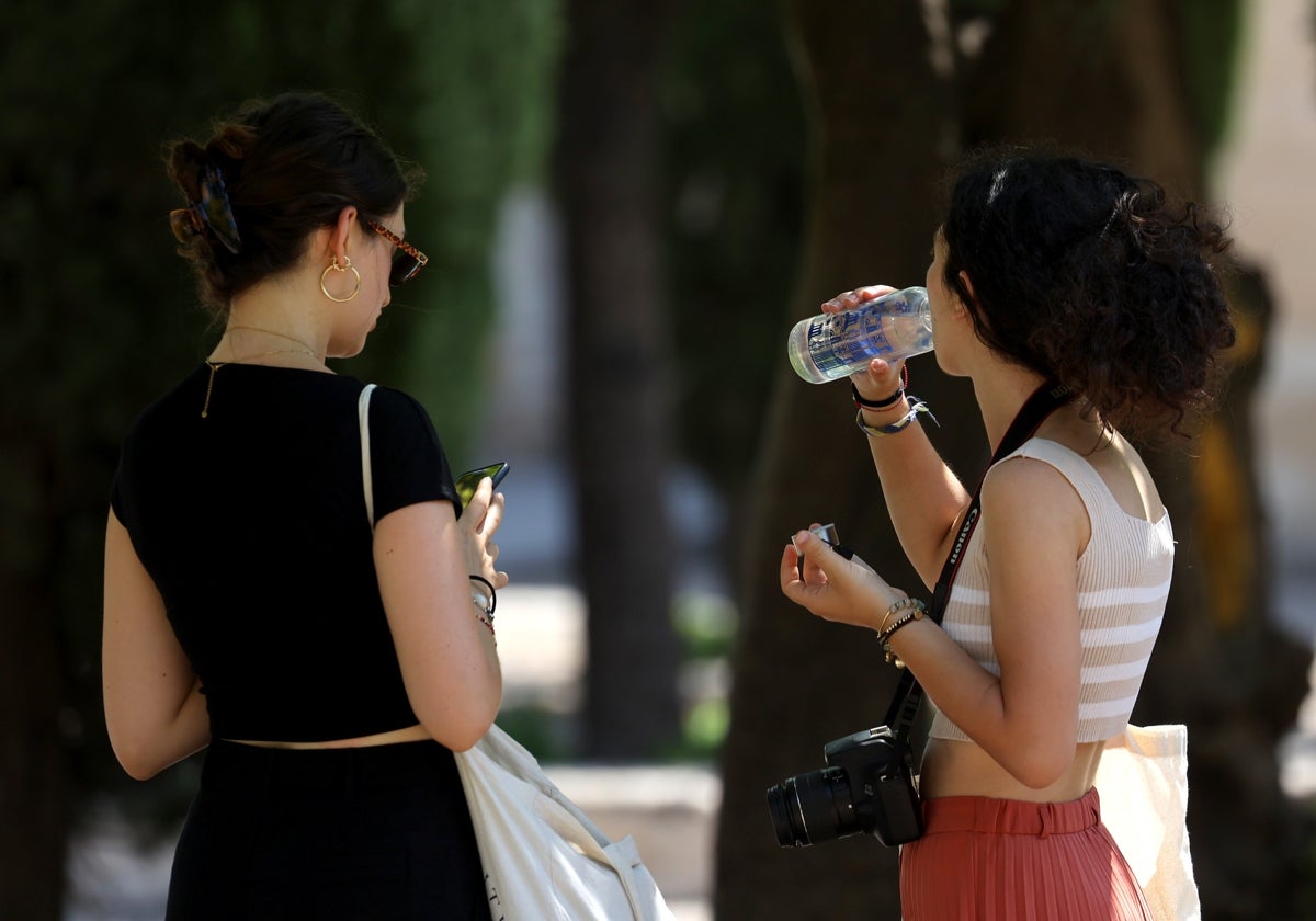 Dos turistas beben agua en una calurosa tarde en Córdoba