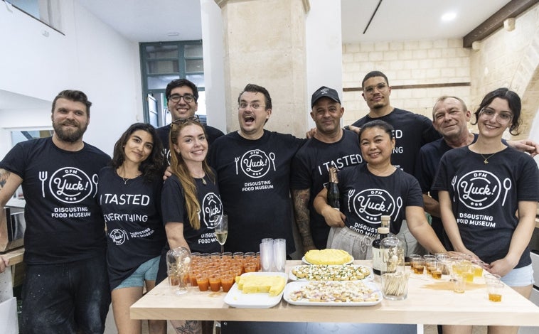 Imagen principal - Arriba, Andreas Ahrens (quinto por la izquierda) y su equipo posan en el local, en Palma, uniformados con la camiseta negra que acredita que ellos «lo probaron todo».