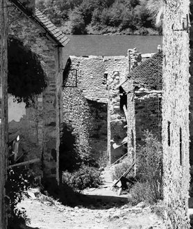 Imagen secundaria 2 - Arriba, el embalse de Lanuza donde se practican deportes náuticos. Abajo, un detalle de las calles y a la derecha, en 1985, aún por reconstruir por sus vecinos