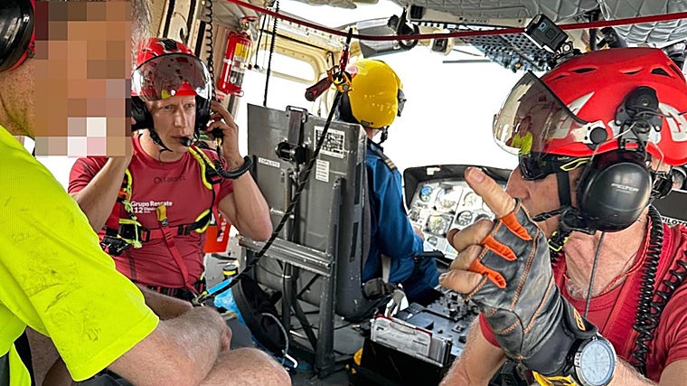 El montañero a bordo del helicóptero junto a los bomberos, de regreso