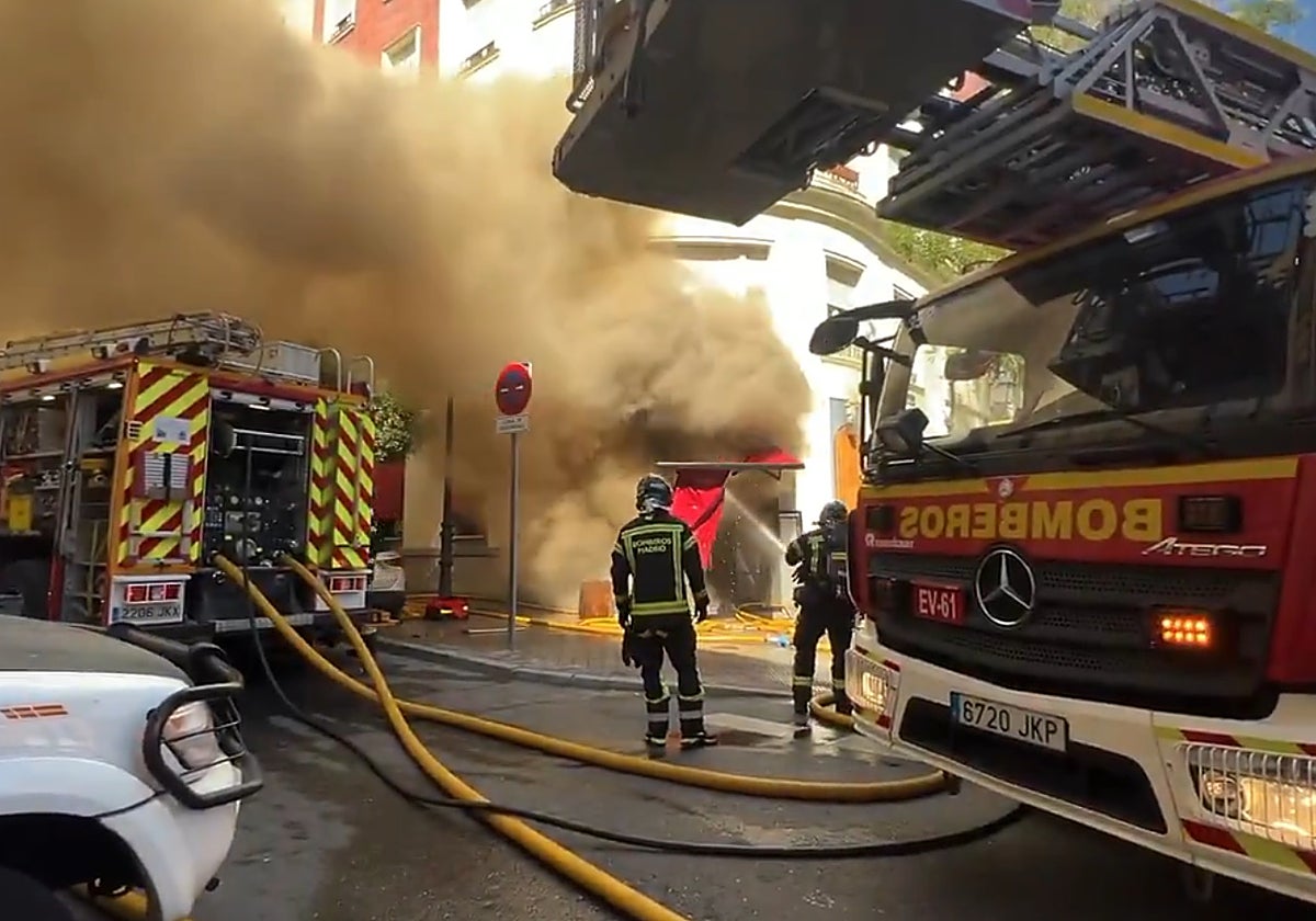 Los Bomberos trabajan para extinguir el fuego, en la calle de Amador de los Ríos