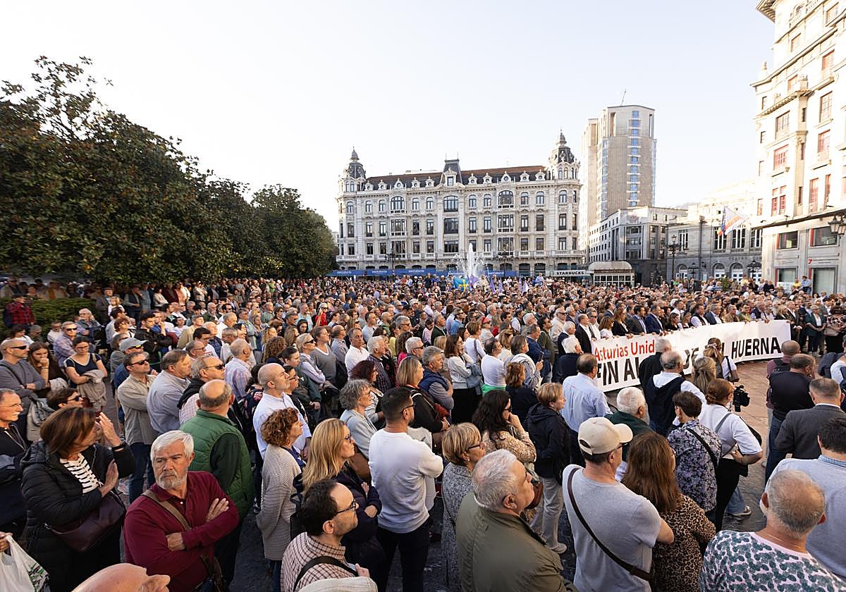 Varias personas con una pancarta, durante la manifestación en contra del peaje del Huerna.
