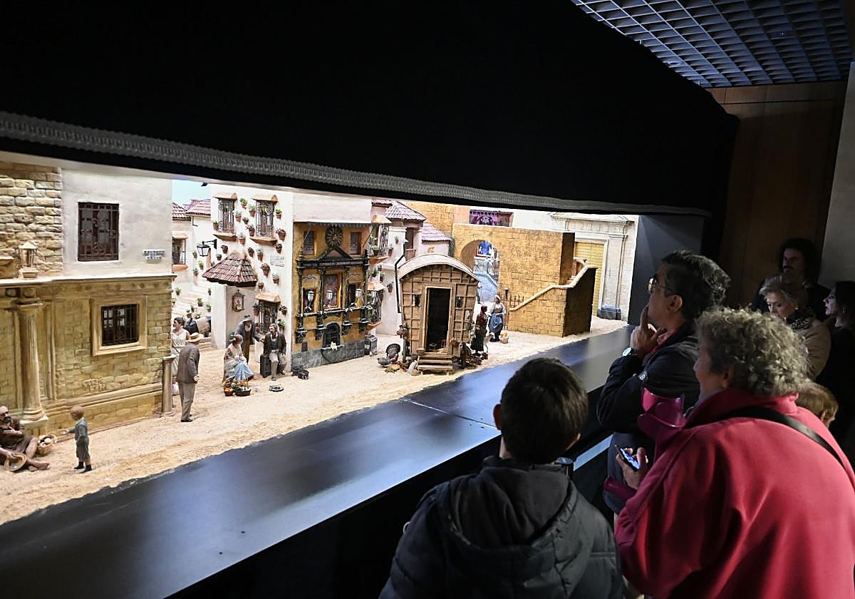 Varias personas observan el belén de la Fundación Cajasol en Córdoba