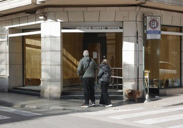 Cartel que indica el cierre temporal en la fachada principal de la clínica dental de Alzira